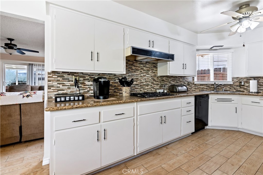 10409 Pendleton Street Riverside, CA 92505 - Photo 12 of 35 a kitchen with white cabinets and appliances