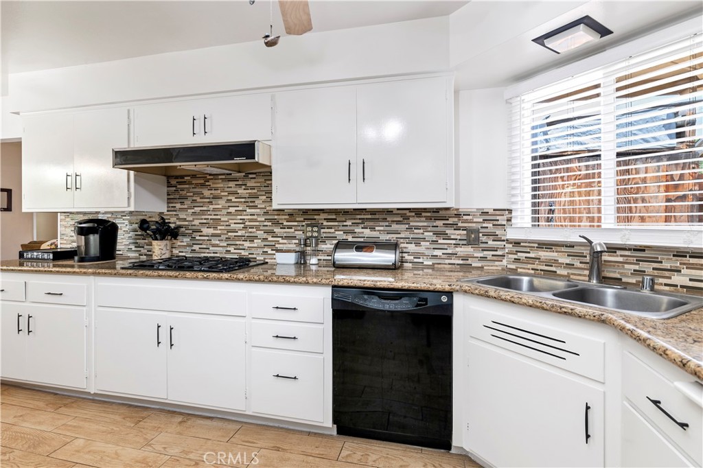 10409 Pendleton Street Riverside, CA 92505 - Photo 13 of 35 a kitchen with granite countertop white cabinets and white appliances
