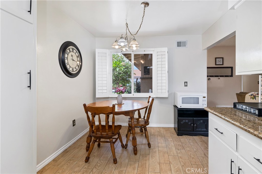 10409 Pendleton Street Riverside, CA 92505 - Photo 17 of 35 a view of a dining room with furniture window and wooden floor