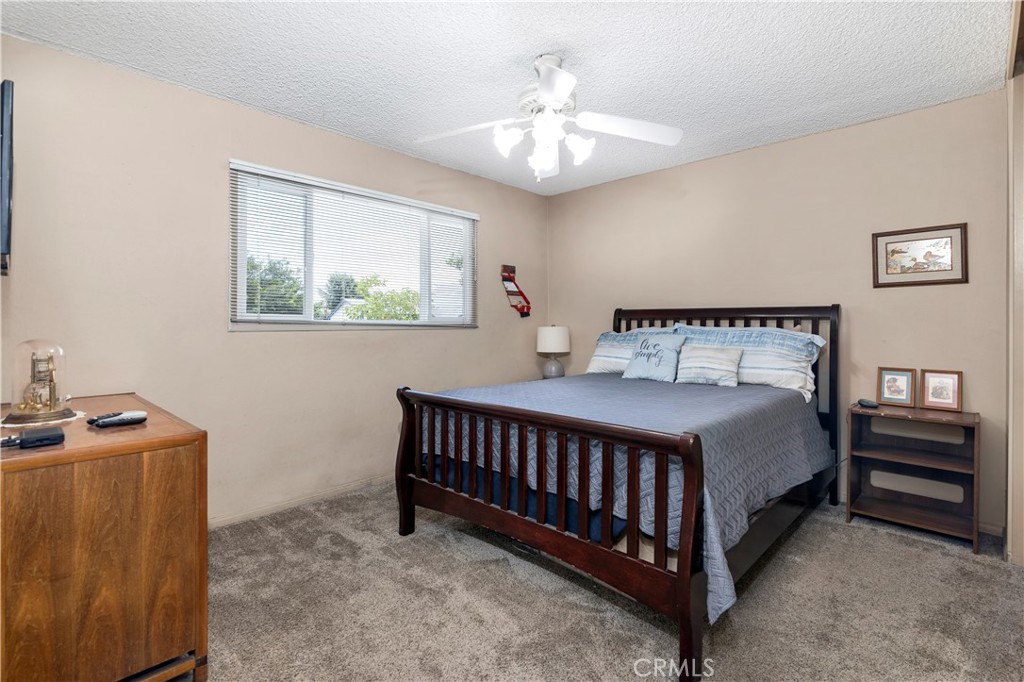 10409 Pendleton Street Riverside, CA 92505 - Photo 19 of 35 a bedroom with a bed and a chandelier