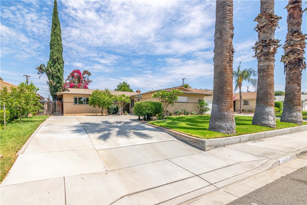 10409 Pendleton Street Riverside, CA 92505 - Photo 2 of 35 a front view of a house with a yard and potted plants