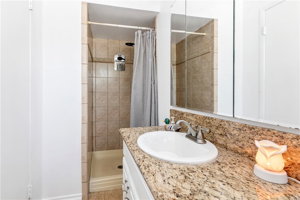 10409 Pendleton Street Riverside, CA 92505 - Photo 21 of 35 a bathroom with a sink and a mirror