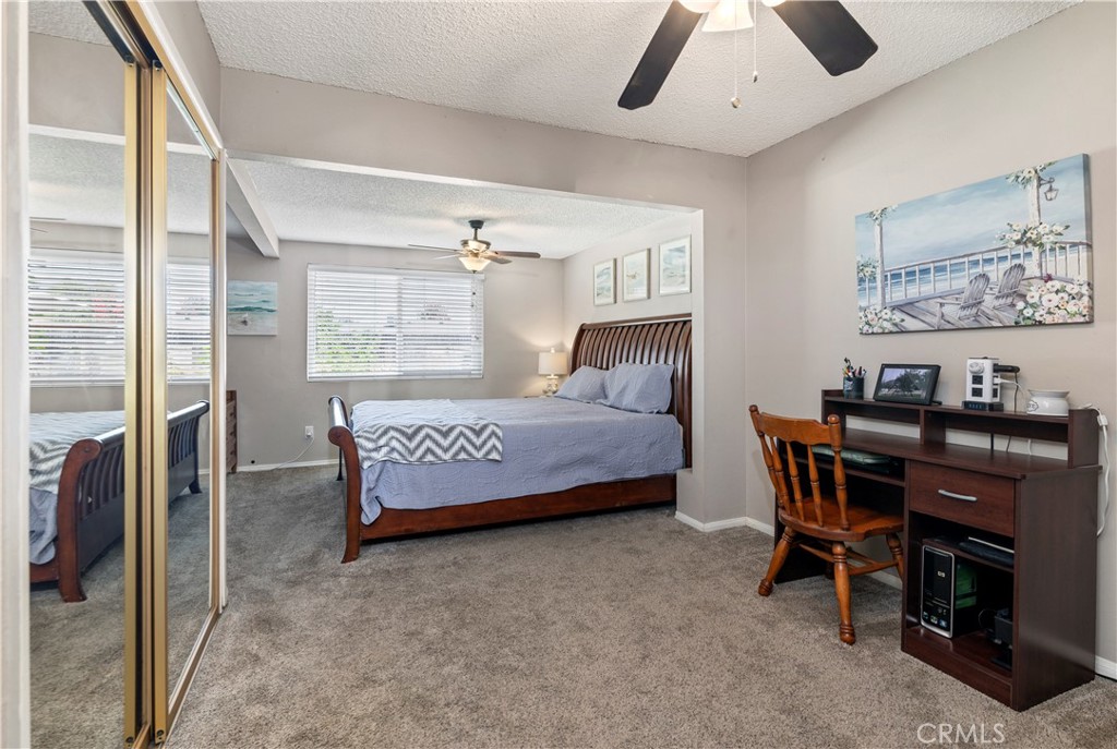 10409 Pendleton Street Riverside, CA 92505 - Photo 24 of 35 a bedroom with a bed and a chandelier