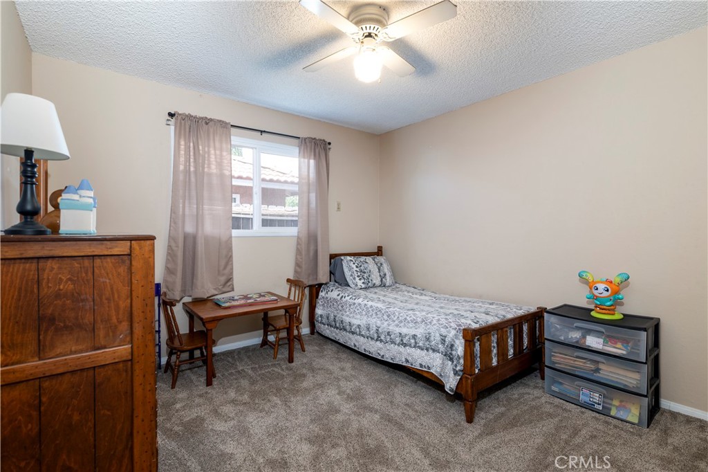 10409 Pendleton Street Riverside, CA 92505 - Photo 25 of 35 a bedroom with a bed and a window