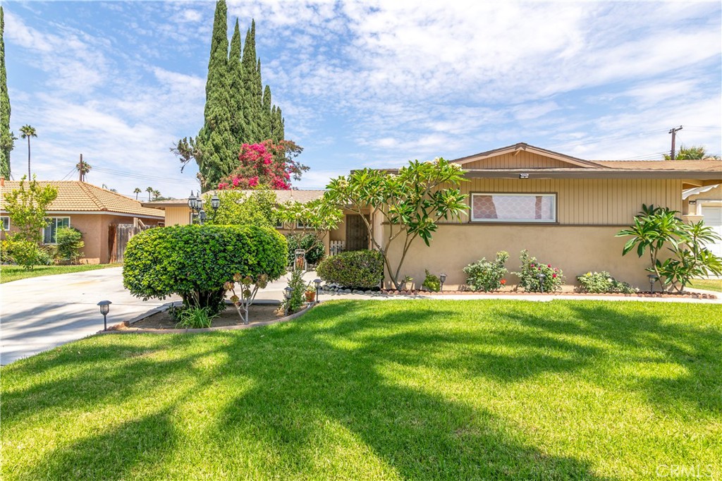 10409 Pendleton Street Riverside, CA 92505 - Photo 5 of 35 a front view of a house with a yard and garage