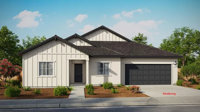 a front view of a house with garage and plants