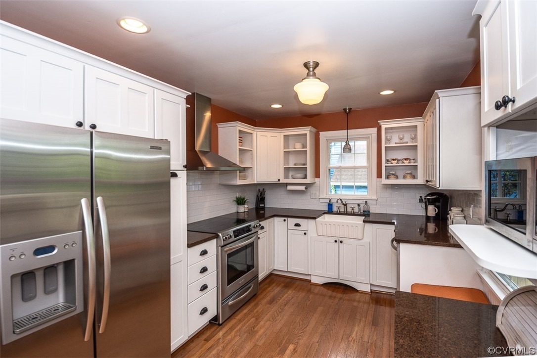 4648 Brookridge Road Chesterfield, VA 23832 - Photo 17 of 50 a kitchen with stainless steel appliances a stove a sink a refrigerator white cabinets and wooden floor