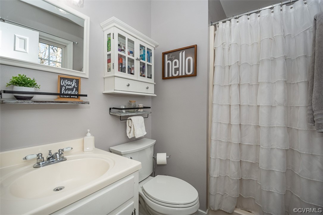 4648 Brookridge Road Chesterfield, VA 23832 - Photo 31 of 50 a bathroom with a sink a toilet and shower curtain