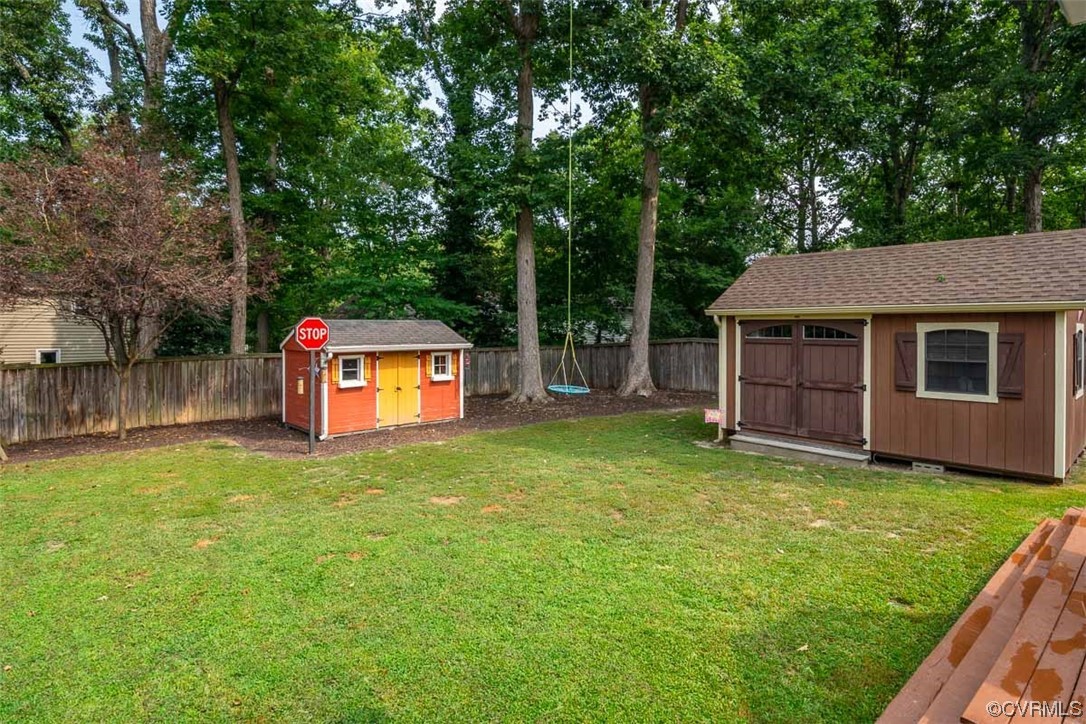 4648 Brookridge Road Chesterfield, VA 23832 - Photo 49 of 50 a backyard of a house with table and chairs plants and large tree