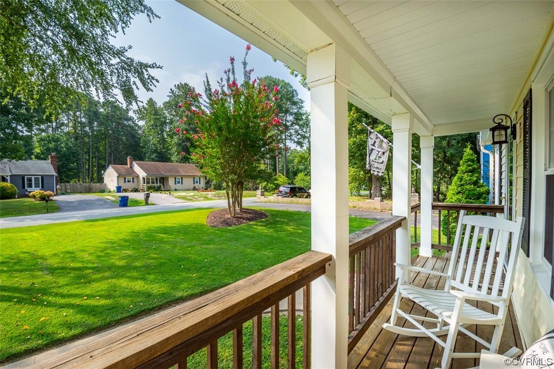 4648 Brookridge Road Chesterfield, VA 23832 - Photo 8 of 50 a view of a patio with table and chairs potted plants and palm tree