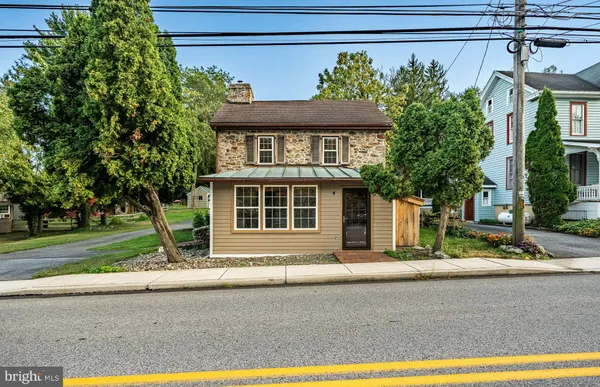 a front view of a house with a yard and a garage