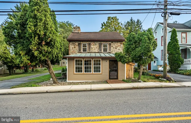 a front view of a house with a yard and a garage