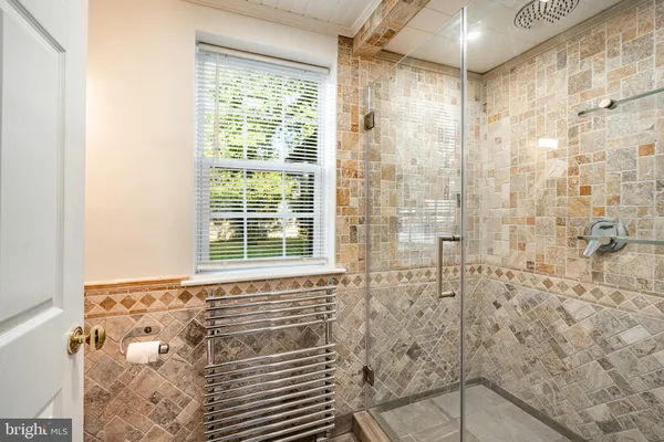 a bathroom with a shower and a sink