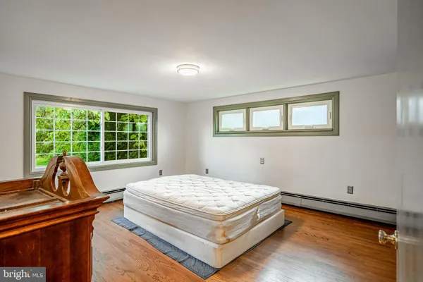 a bed sitting in a room next to a window