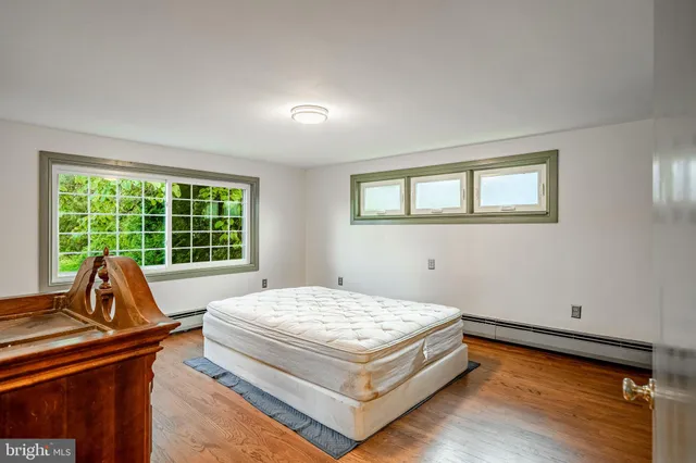 a bed sitting in a room next to a window