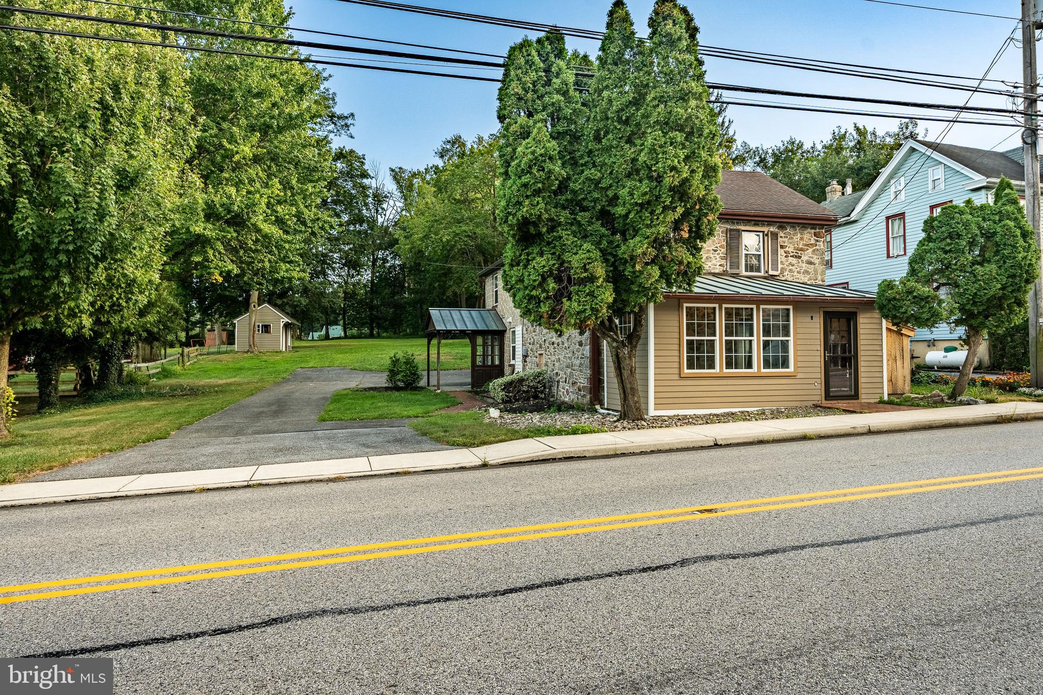 59 East Main Street Elverson, PA 19520 - Photo 2 of 43 a view of a house with a garden and a pathway