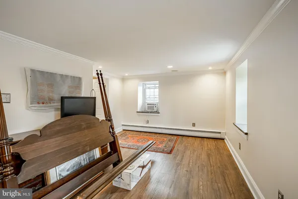 a bedroom with furniture and wooden floor