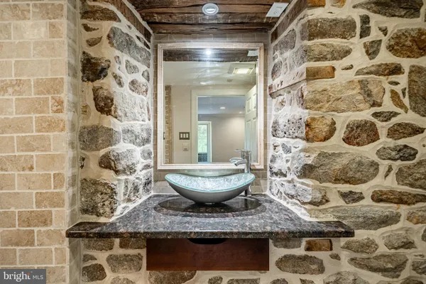a bathroom with a granite countertop sink a toilet and shower