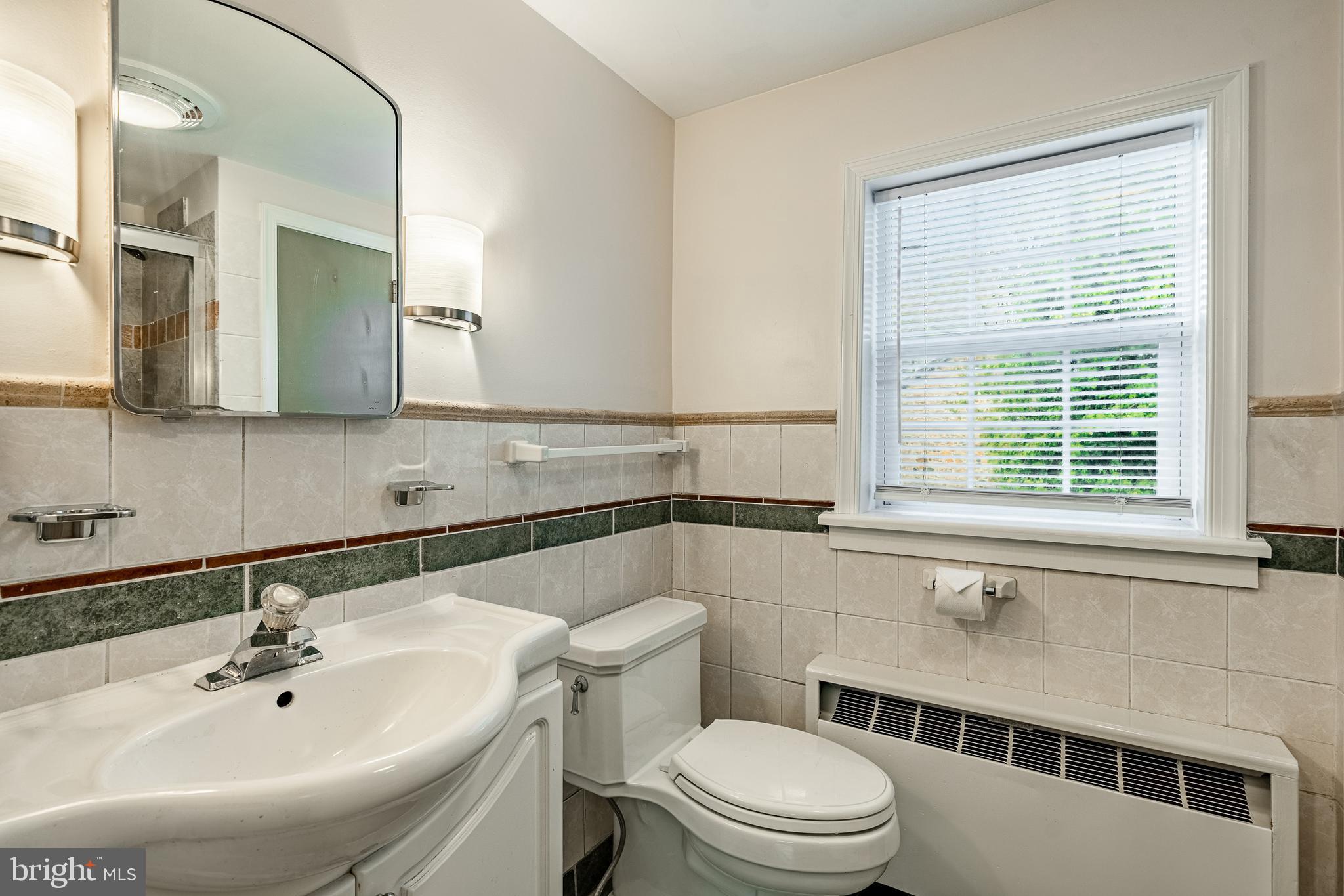 59 East Main Street Elverson, PA 19520 - Photo 30 of 43 a bathroom with a sink a toilet and a mirror