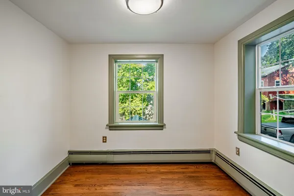 a view of a room with window and wooden floor
