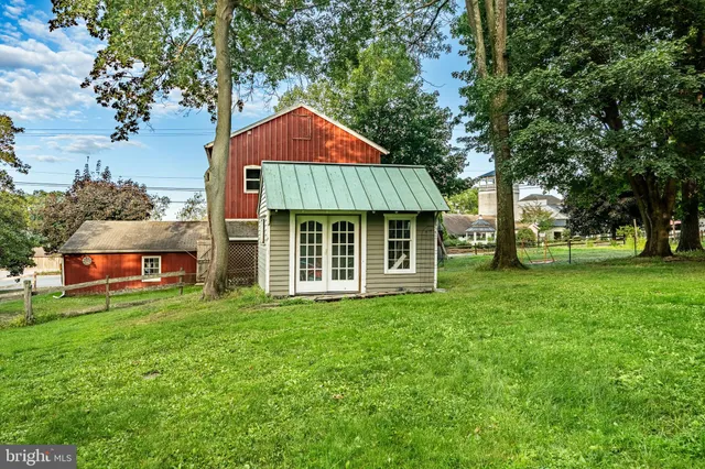 a view of a field with trees in the background