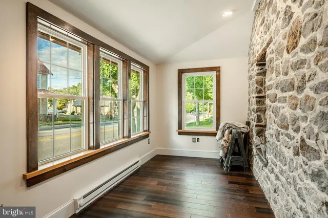 a view of a room with wooden floor and windows