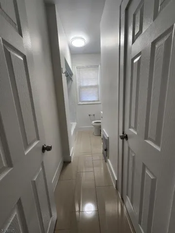 a bathroom with a toilet a sink a mirror and bathtub