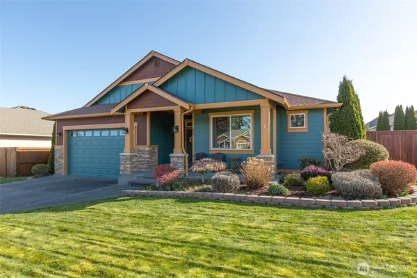 a front view of house with yard outdoor seating and barbeque oven