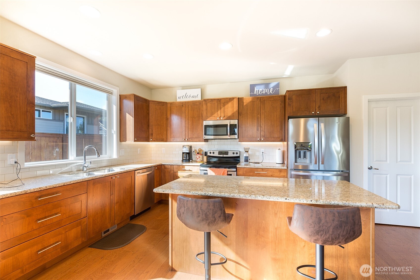 271 Blue Glacier Loop Sequim, WA 98382 - Photo 17 of 39 a kitchen with stainless steel appliances granite countertop a sink and a refrigerator