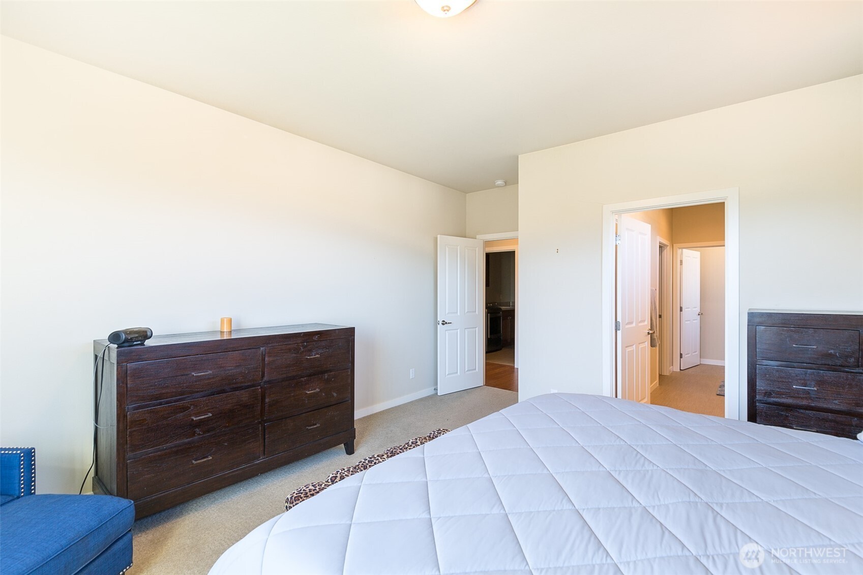 271 Blue Glacier Loop Sequim, WA 98382 - Photo 23 of 39 a bedroom with a bed and a dresser