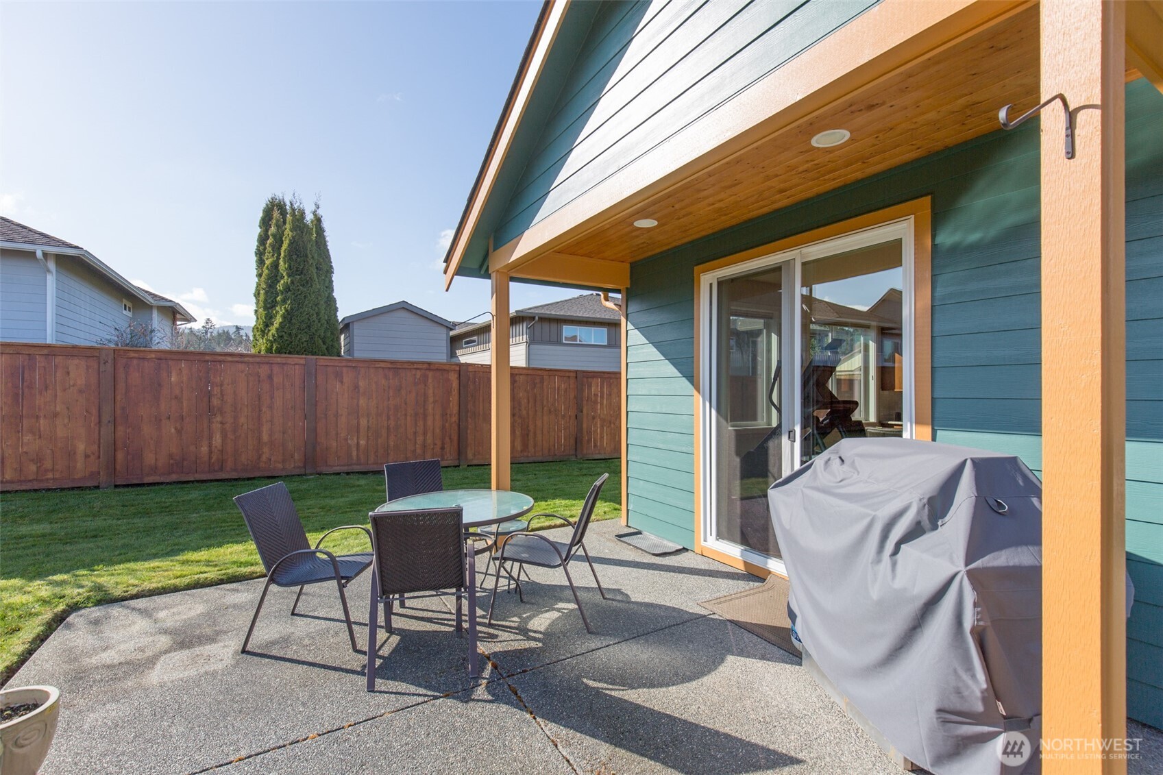 271 Blue Glacier Loop Sequim, WA 98382 - Photo 27 of 39 a view of a patio with a table and chairs and potted plants