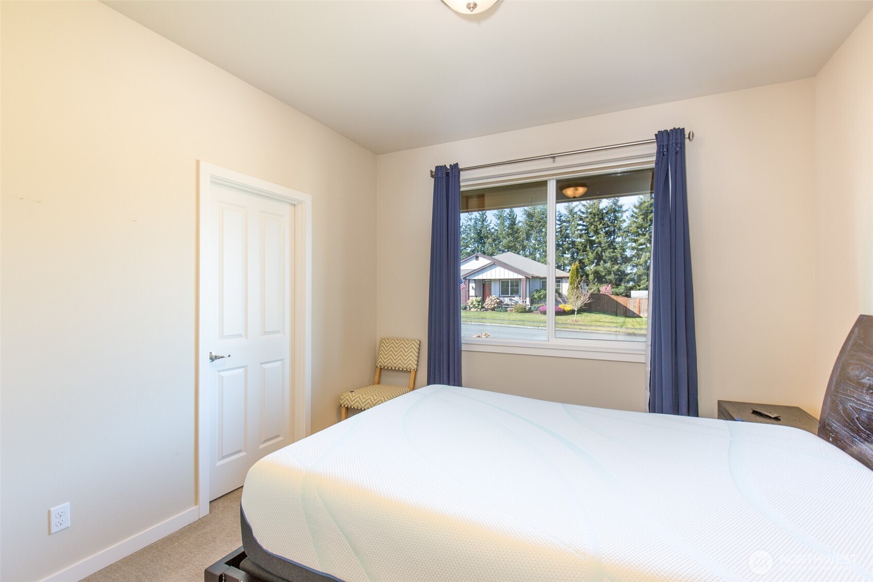 271 Blue Glacier Loop Sequim, WA 98382 - Photo 9 of 39 a bedroom with a bed and a window