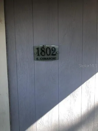 a view of a room with wooden floor and a window