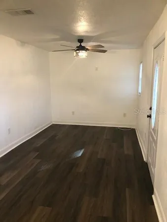 a kitchen with granite countertop a refrigerator and a sink