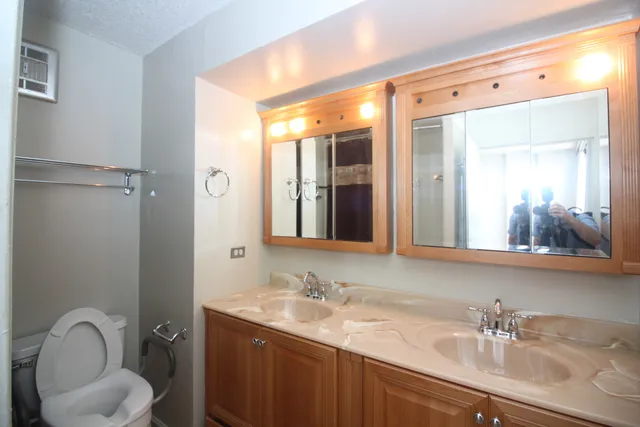 a bathroom with a granite countertop sink mirror and vanity
