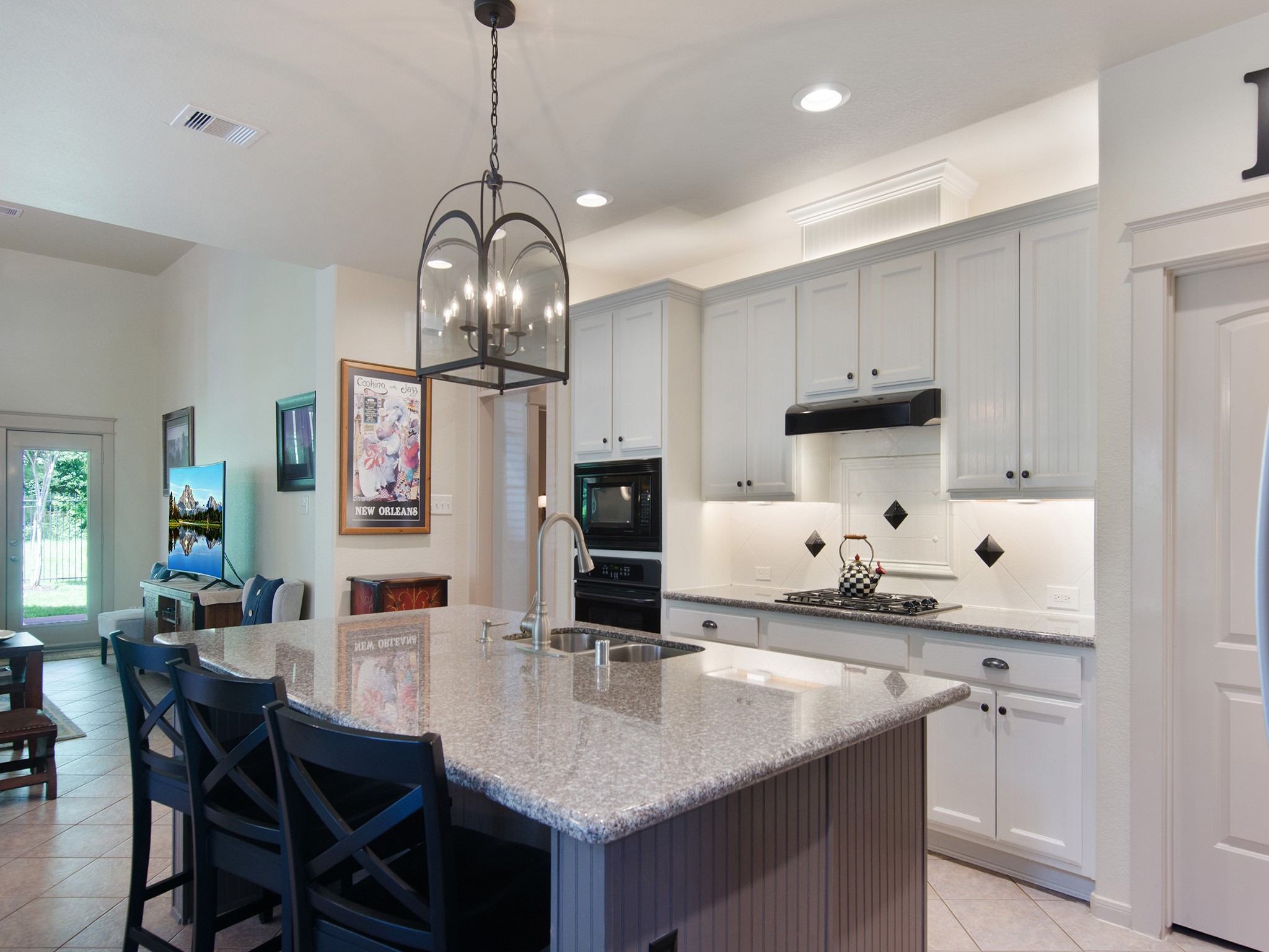 28323 Ryans Ridge Lane Spring, TX 77386 - Photo 8 of 45 Notice the designer lantern-style light fixture and the contrasting island finish, thoughtful details that enhance the kitchen's transitional design and visual appeal.