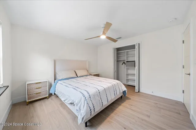 a bedroom with a bed and a lamp