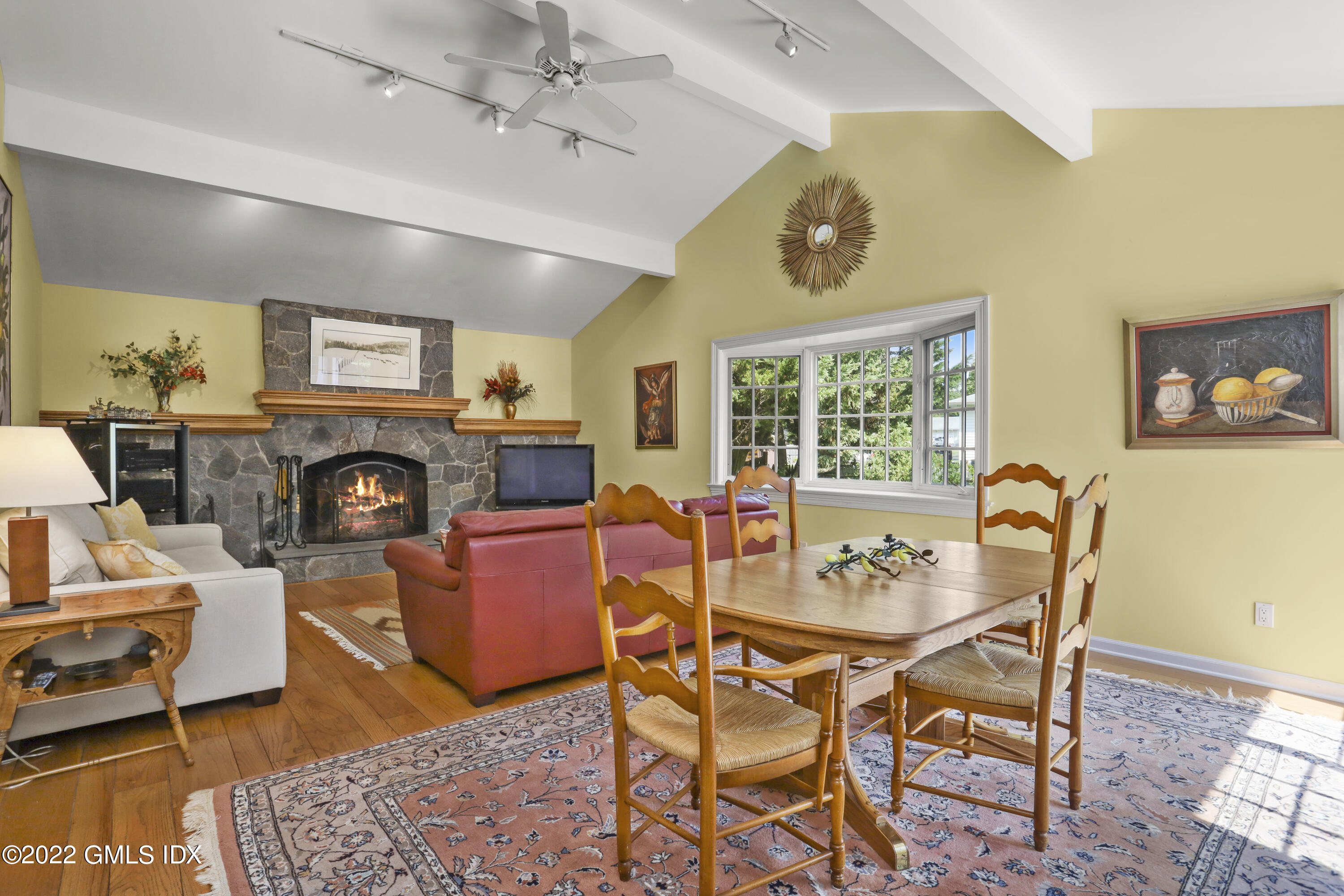 90 Carter Drive Stamford, CT 06902 - Photo 12 of 40 a dining room with furniture a fireplace and wooden floor
