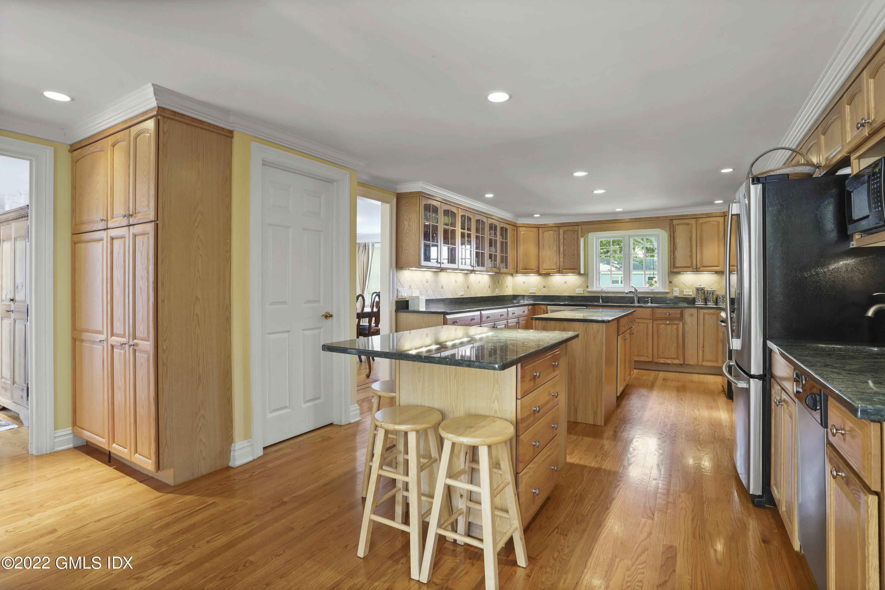 90 Carter Drive Stamford, CT 06902 - Photo 17 of 40 a kitchen with stainless steel appliances granite countertop a refrigerator and a sink