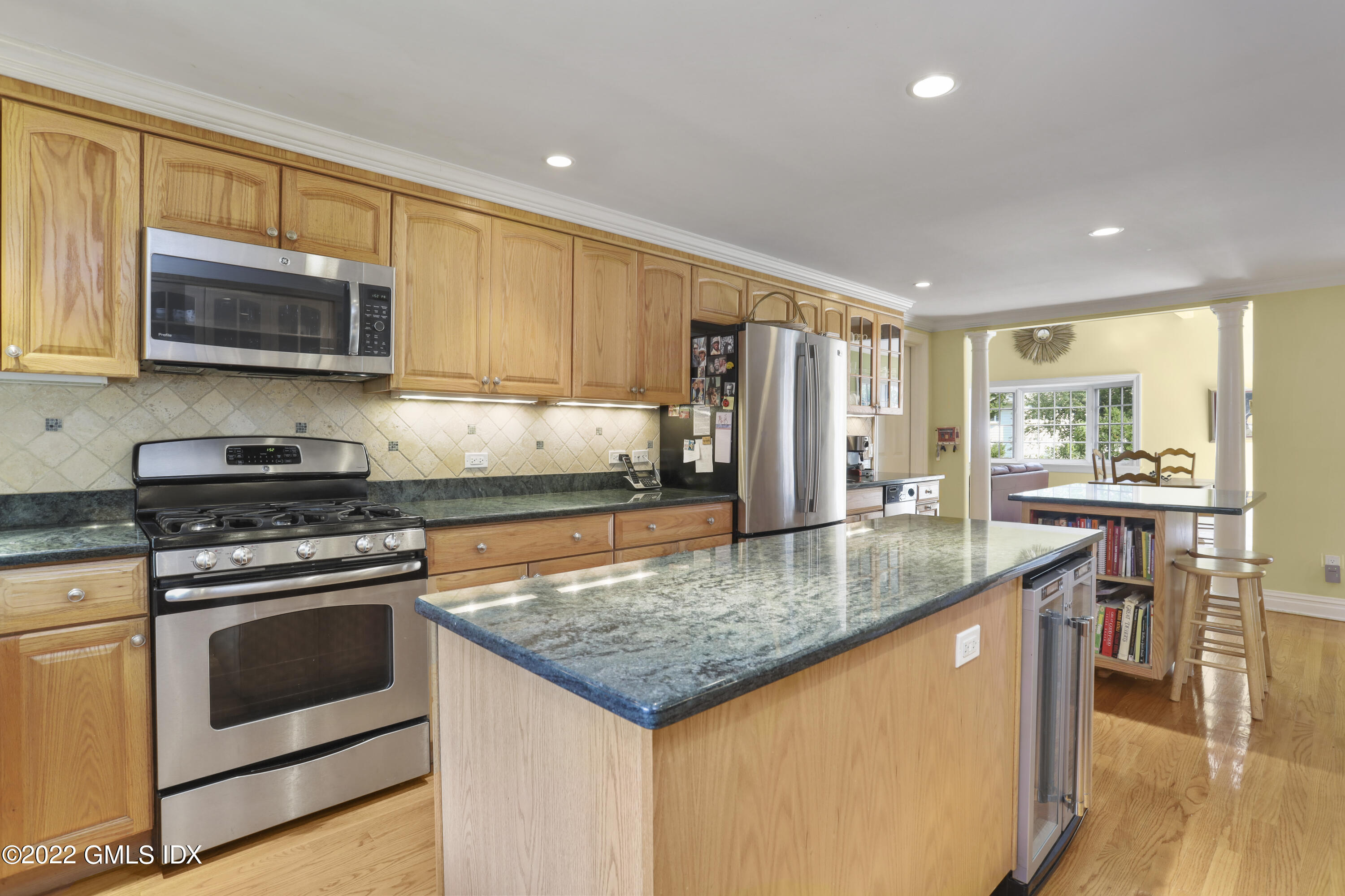 90 Carter Drive Stamford, CT 06902 - Photo 18 of 40 a kitchen with stainless steel appliances granite countertop a stove top oven a sink and a refrigerator