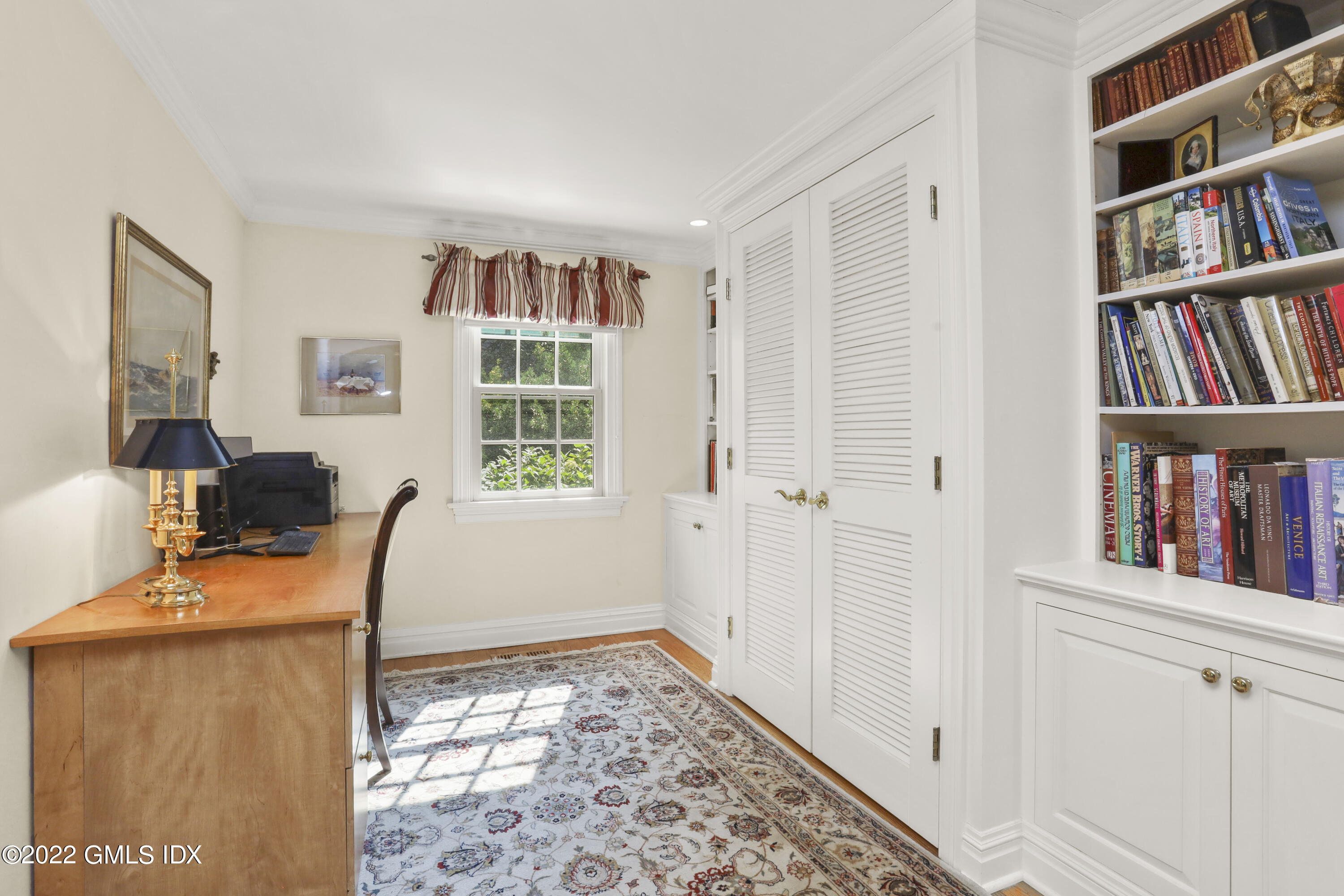 90 Carter Drive Stamford, CT 06902 - Photo 23 of 40 a view of a workspace with furniture and a book shelf