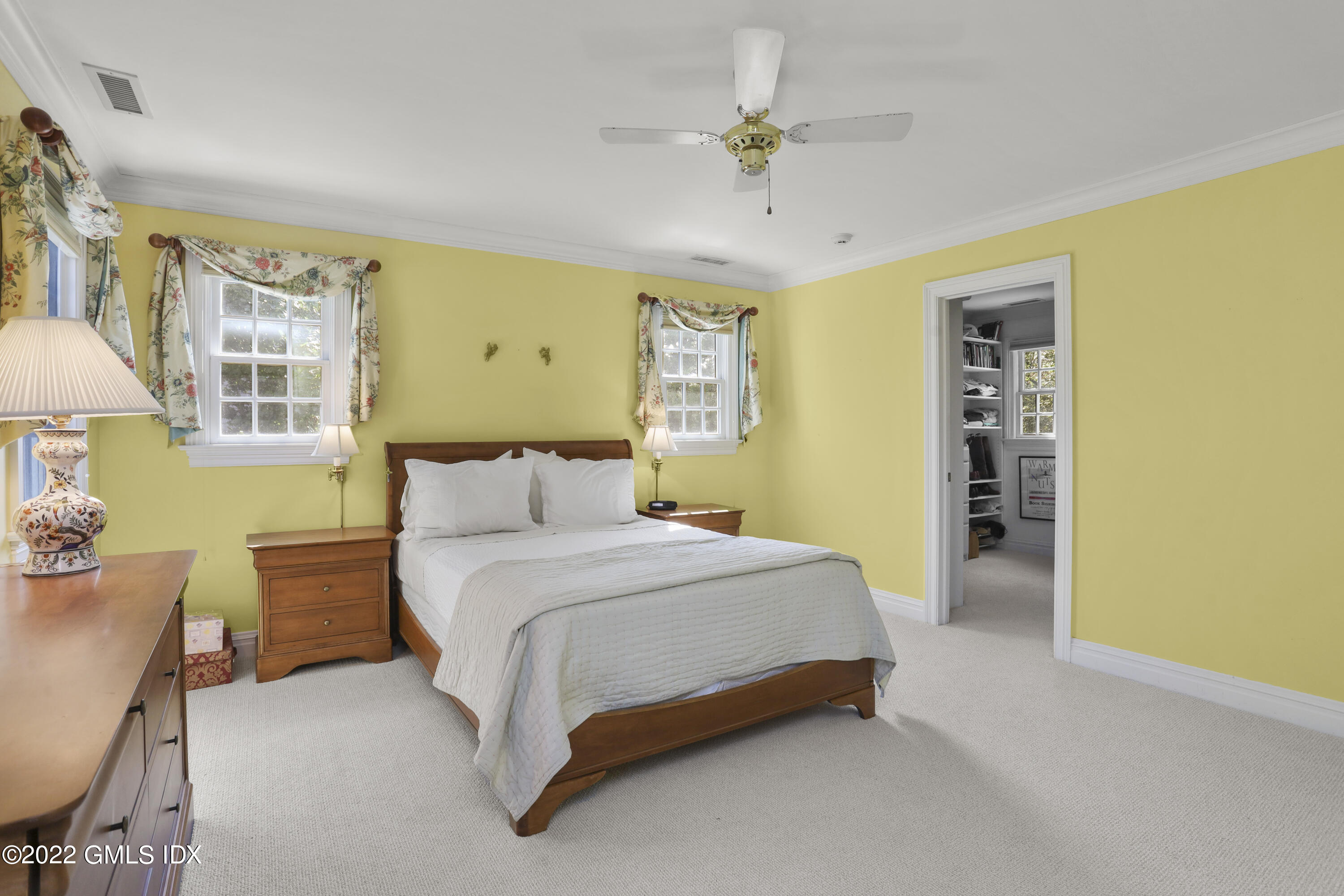 90 Carter Drive Stamford, CT 06902 - Photo 32 of 40 a spacious bedroom with a bed and a chandelier