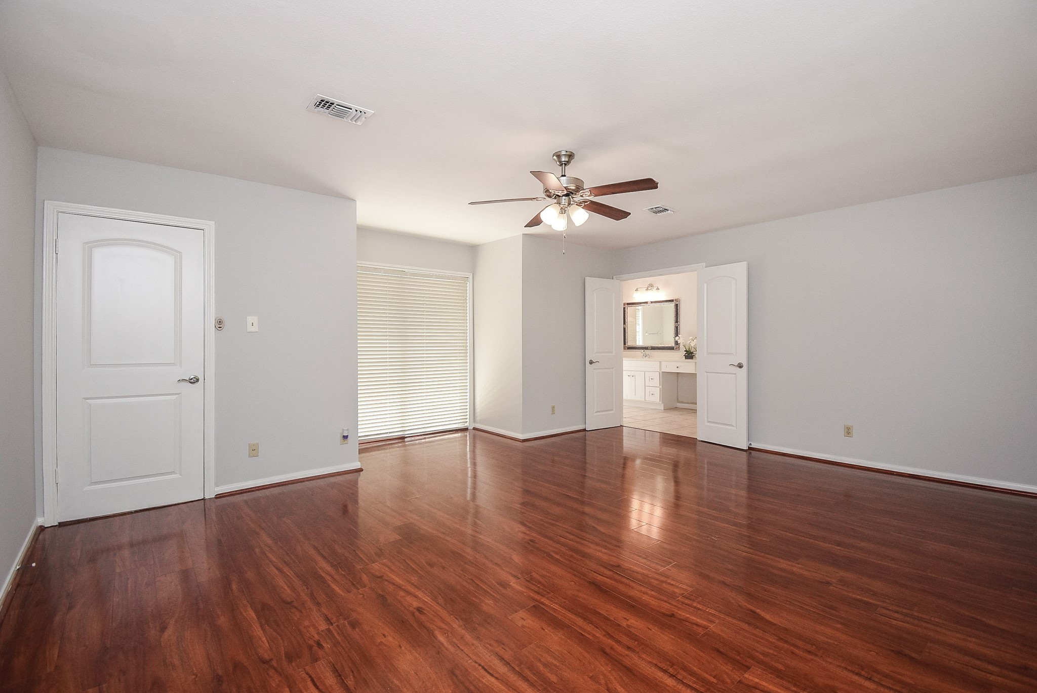 201 Vanderpool Lane, Unit 113 Houston, TX 77024 - Photo 24 of 45 a view of an empty room with a window and wooden floor
