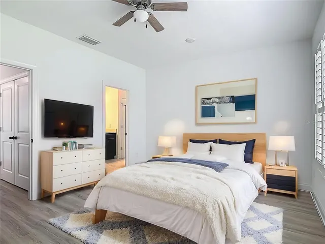 a bedroom with a bed and a flat screen tv