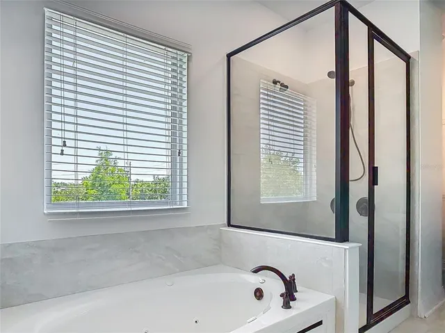 a bathroom with a bathtub and a window