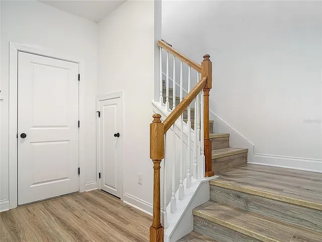 a view of entryway and hall with wooden floor