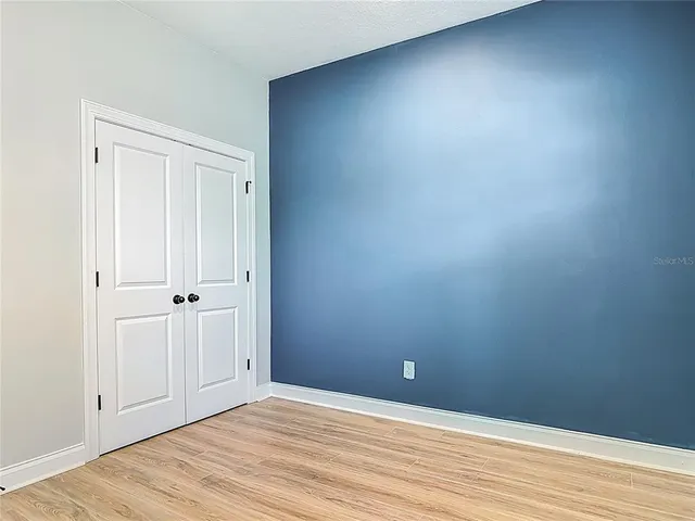 an empty room with wooden floor