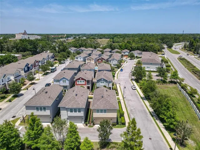 an aerial view of residential houses with outdoor space