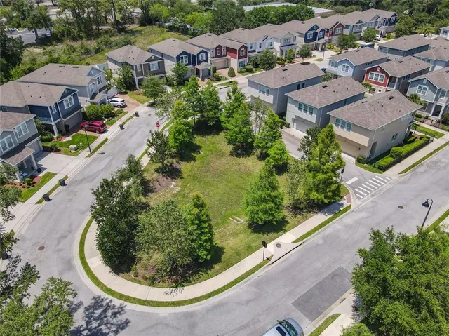 an aerial view of a residential houses with outdoor space and street view