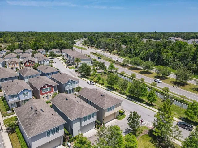 an aerial view of residential houses with outdoor space and street view